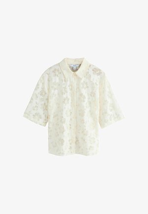 Kurzärmliges Hemd mit Kragen aus hellcremefarbenem Stoff und floraler Spitze, das eine lockere Passform und dezente Stickdetails aufweist.