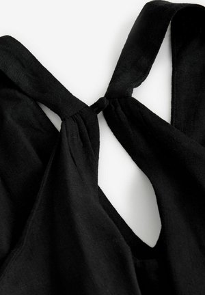 Fekete szövet felső, a hátsó részen megkötős dizájnnal, hullámokkal, amelyek lágy redőzést és sima textúrát hoznak létre.