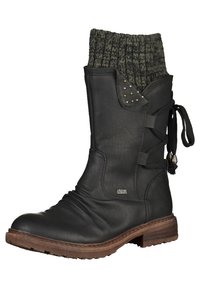 Botte en cuir noire mi-mollet avec bord côtelé en tricot, détails de laçage latéral avec pompons, petits clous métalliques, et une semelle empilée marron.