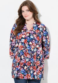 Blomsterbluse i navy med røde, pink og blå blomster. Har en v-hals og trekvartærmer. Lavet af letvægtsstof.