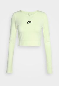 Hosszú ujjú, cropped topp világos neon sárga anyagból, kerek nyakkivágással és egy kis fekete Nike logóval középen a mellrészen.