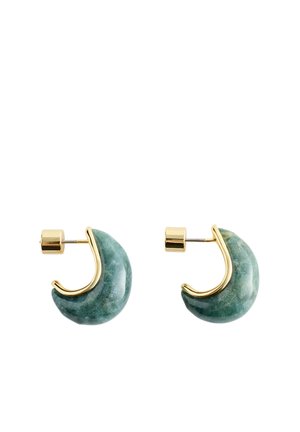 Paire de boucles d'oreilles en forme de croissant en pierre verte avec bords en métal doré et tiges droites avec attaches cylindriques.