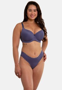 Purple bra and matching thong with scalloped edges. Bra features underwire and small decorative bow at the center. Smooth fabric texture.