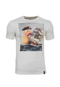 White cotton t-shirt featuring a graphic of a large rubber duck in a captain's hat alongside a sailing ship against a water background.