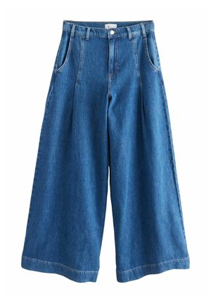 Keskmise sinise tooniga laiad denim-püksid, kõrge vöökohaga, ees volditud, küljetaskute ja nähtava õmblusega hemme ääres.