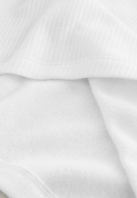 White fabric with a ribbed texture on the visible edge, soft and smooth appearance, featuring a clean, seamless design.
