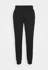 Musta verkkarihousut, joissa on kiristysnyöri vyötäröllä, kapeat lahkeet ja joustavat hihansuut. Valmistettu pehmeästä kankaasta. Minimalistinen muotoilu, ei näkyviä kuvioita.