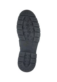 Black rubber shoe sole featuring a rugged tread pattern with cross and rectangular lugs. Embossed brand name "GANT" and size "42."