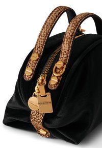 Black velvet bag with brown animal-print handles, gold zipper and hardware, featuring an engraved logo plate and elegant curved shape.