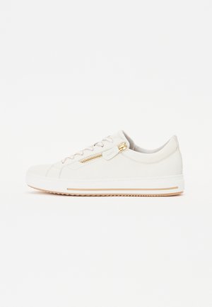 White leather sneakers with a low profile, featuring a side zipper, light beige laces, and a rubber sole with gold accents.