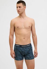 Boxershorts mit einem schwarzen Bund, auf dem "JACK & JONES" steht, gemustert in Dunkelblau mit Blattmotiven und einer engen, figurbetonten Passform.