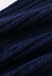 Navy blue ribbed knit fabric with a soft texture, featuring vertical lines and slight variations in shade. Ideal for casual wear.