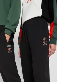 Lacoste EXCLUSIVE UNISEX - Tréningruha alsók - black