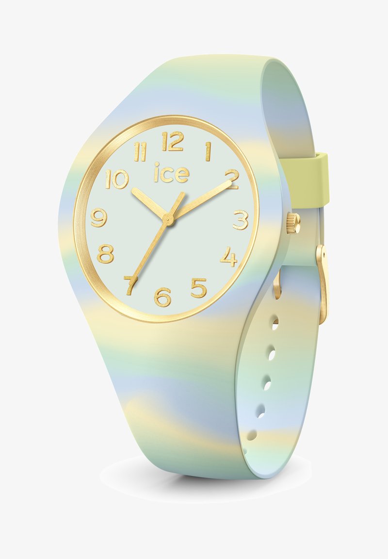 Pasteļtoņu gradienta silikona pulkstenis ar zelta tonī dialu, kurā ir arābu cipari un zelta stundu un minūšu rādītāji. Regulējams siksna ar caurumiem.