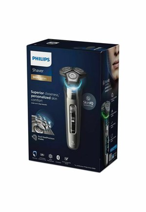 Philips Shaver 9000 Series packaging features a sleek, silver shaver with a three-headed design and illuminated display on a dark blue background.