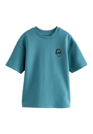 T-shirt a maniche corte in tessuto teal con scollatura rotonda. Presenta un piccolo design di teschio nero con cuffie sul lato sinistro del petto.