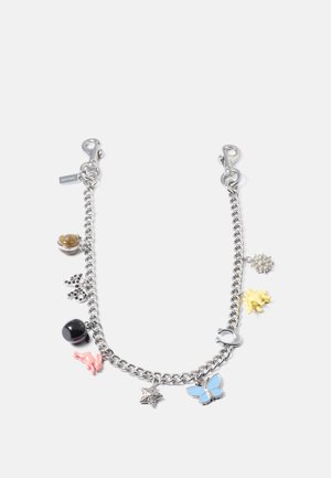 Silver chain bracelet featuring colorful charms: yellow flower, blue butterfly, pink rabbit, black stone, and silver star, with lobster clasp.