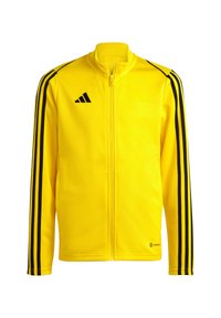 Geel zip-up jack van glad materiaal met zwarte strepen op de schouders en mouwen, met een Adidas-logo op de borst.