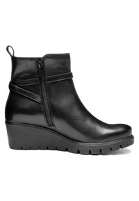 Black leather ankle boot with wedge sole, side zipper, and decorative straps, featuring a pull tab at the back for easy wear.
