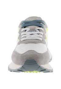 Gray and white athletic shoes, featuring a smooth leather and suede upper, blue laces, and a textured rubber sole with neon accents.