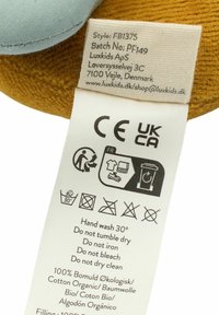 Cotton fabric label featuring care instructions. Beige background with black symbols. Includes product details and eco-friendly certifications.
