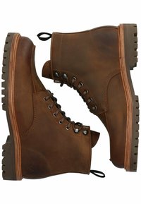 Stivaletti in pelle marrone con punta rotonda, occhielli in metallo e suola robusta. Presentano un tassello per il pull e dettagli di cucitura a contrasto.