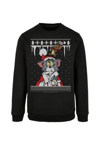 Zwarte sweatshirt met een feestelijk ontwerp van Tom en Jerry. Tom draagt een kerstmuts en houdt een sneeuwbol vast, omringd door sneeuwvlokken en bomen.