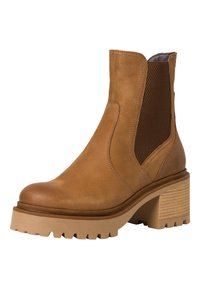 Bottines en cuir marron avec des panneaux élastiques sur les côtés, finition texturée et un talon large évasé. Dotées d'une semelle avec un profil rugueux pour une meilleure adhérence.