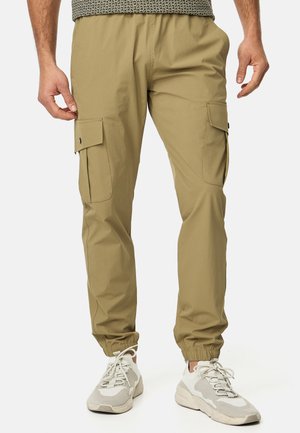 Khaki cargo pants with an elastic waistband, side pockets, and elastic cuffs. Made of lightweight fabric with a smooth texture.