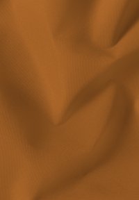 Smooth orange fabric with visible texture and soft folds creating gentle shadows and highlights.