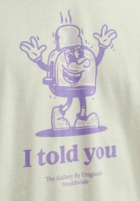 Short-sleeve light beige t-shirt featuring a purple cartoon toaster with a slice of toast, smiling and waving, and text below saying "I told you."