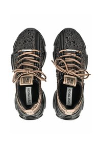Sneaker nere e beige con tomaia testurizzata, caratterizzate da motivi intricati, lacci tondi e suola nera imbottita. Etichetta del marchio visibile.