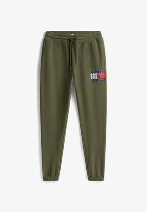 Olive green joggers with elastic waistband, drawstring, and tapered legs. Features a logo patch in red, white, and blue on the thigh.