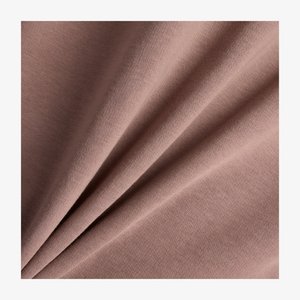 Weicher, mauvefarbener Baumwollstoff mit glatter Textur, der sanfte Falten aufweist, die Tiefe erzeugen und den Fall des Stoffes betonen. Keine klaren Muster sichtbar.