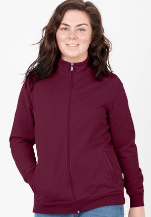 Felpa zip-up bordeaux con colletto alto, tasche laterali e polsini a costine. Realizzata in tessuto morbido con una texture liscia.