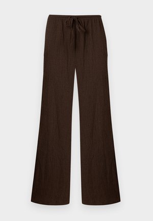 Pantalon large à jambes larges de couleur brun foncé avec texture, taille élastique et cordon de serrage à l'avant, posé à plat sur un fond clair.