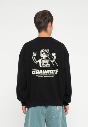 Black sweatshirt with a crew neck, featuring a graphic of a robot design on the back, accompanied by "Carhartt" text and detailing.