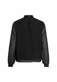 Blouse noire à manches longues avec motif texturé en chevrons, manches transparentes, poignets smockés et petite fermeture bouton au dos de l'encolure.