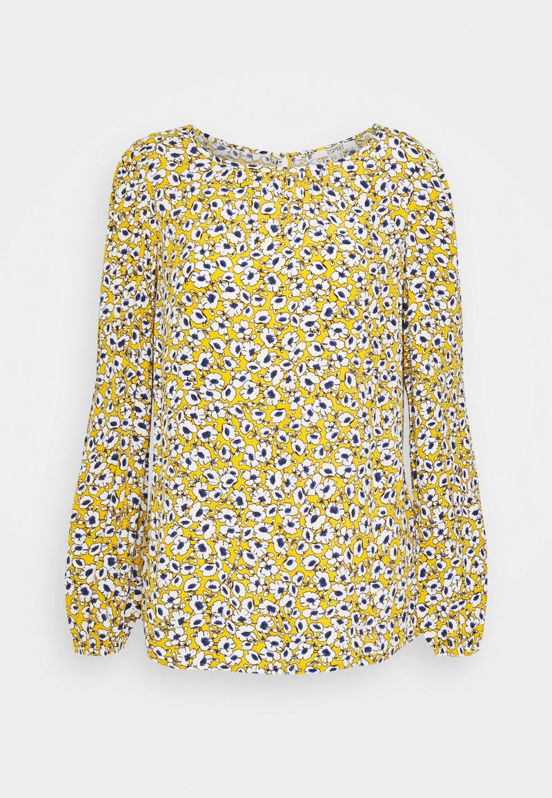 Blouse jaune à manches longues avec un col froncé et des poignets élastiques, présentant un motif floral dense blanc et bleu.