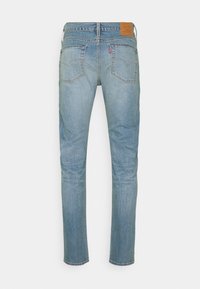 Blå denimjeans med rak benform, som har en märkesläderlapp på baksidan, två bakfickor och minimal blekning.
