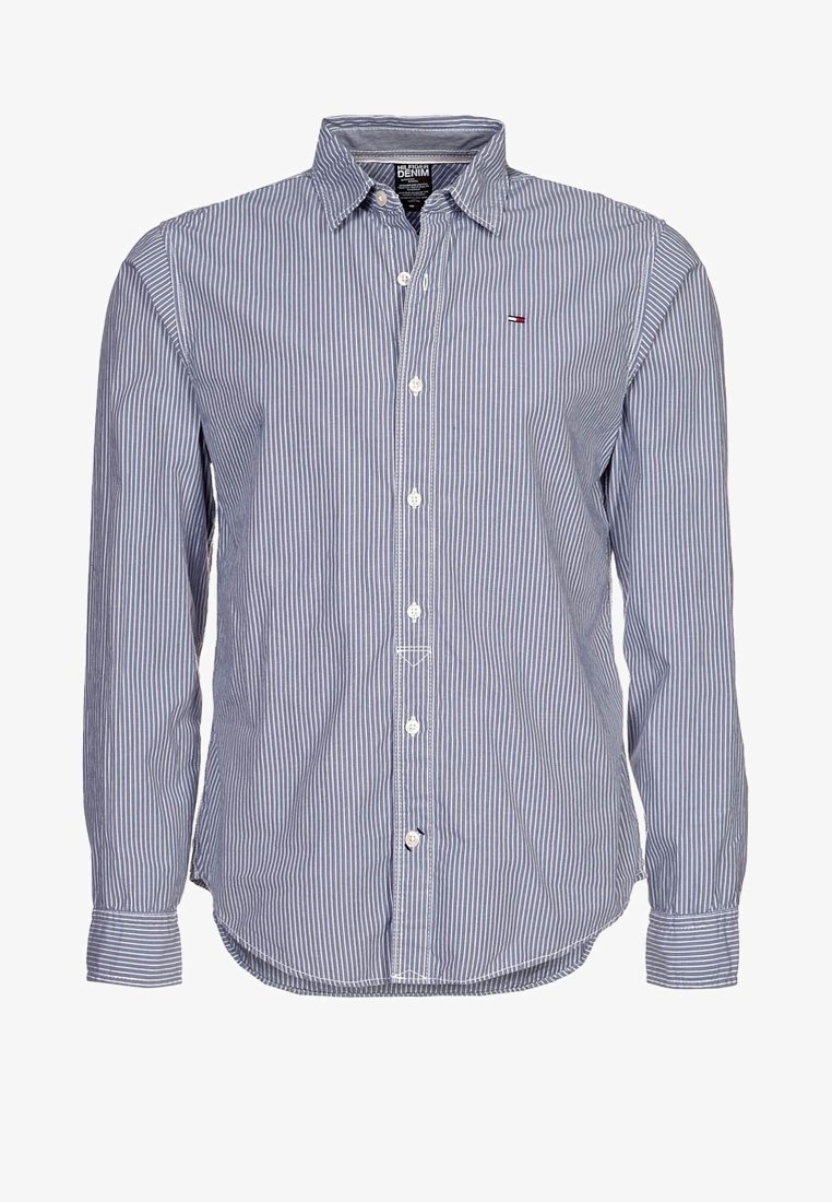 Knappad skjorta med långa ärmar, blå och vita vertikala ränder. Har en klassisk krage, framknäppning och liten logotyp på bröstet.