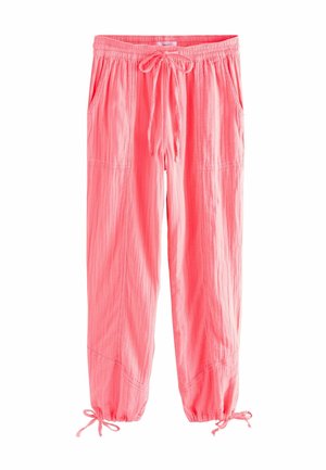 Pantalon léger rose avec taille élastique et cordon, poches latérales et liens aux poignets élastiqués.