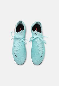 Light blue athletic shoes with textured fabric, round toe, flat laces, and a black swoosh logo. Cushioned interior with a black insole.