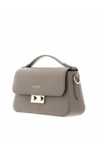 Grey leather handbag with a structured shape, flap closure, metallic hardware, and a top handle. Features embossed logo on the front.