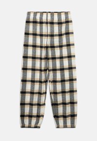 Plaid pants in gray, black, and beige. Made of soft fabric, with an elastic waistband and tapered ankles. Features a large check pattern.