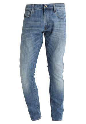 Faded blue slim-fit jeans with button and zipper closure, front and back pockets, and subtle whiskering details.