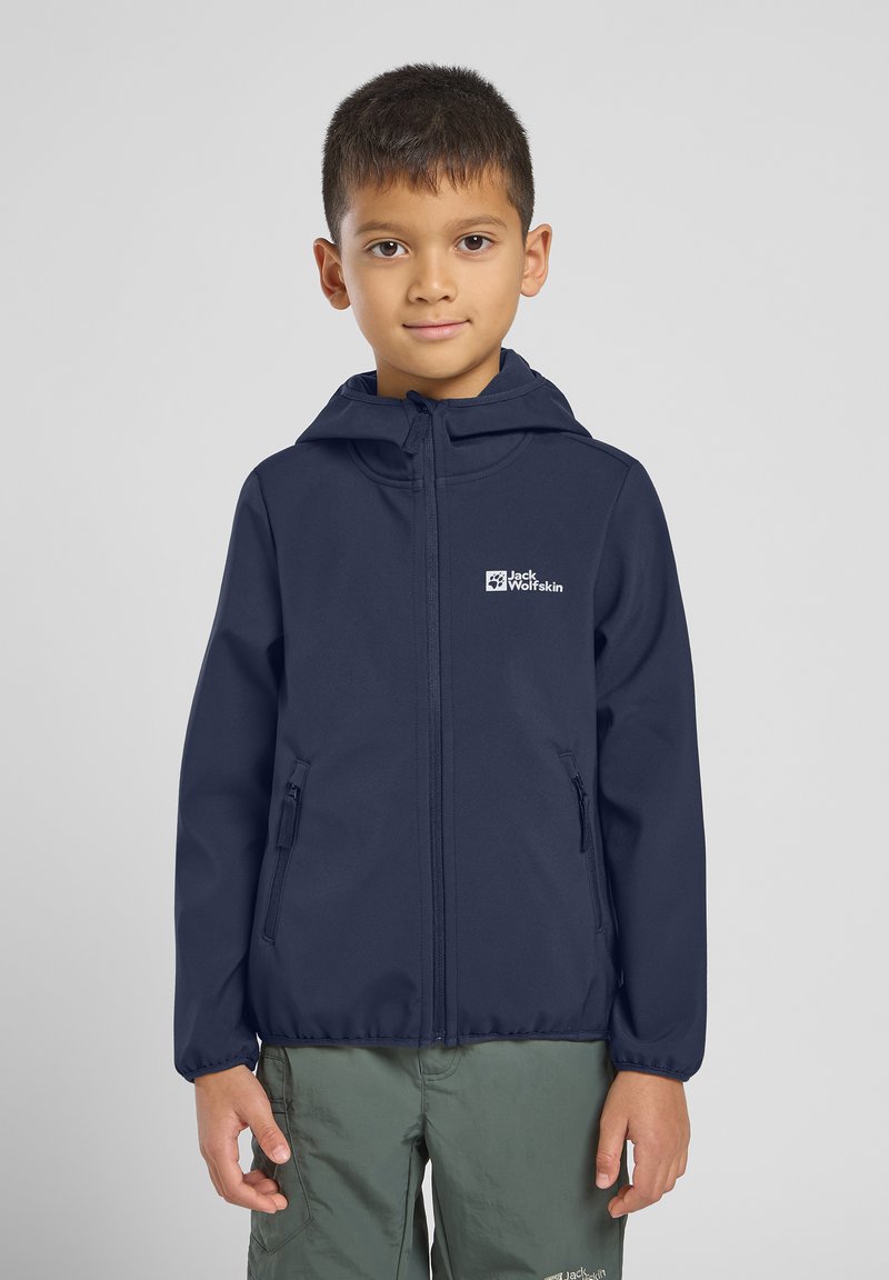 Navy blue softshell jacket with a hood, two zippered side pockets, and a logo on the chest, made from a lightweight, water-resistant material.