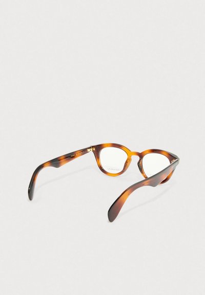 Acetatbrille im Schildpattmuster mit runder Form. Klarsichtgläser und goldene Hardwaredetails an den Scharnieren.