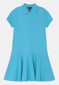 Polomekko kirkkaassa sinisessä puuvillassa, jossa istuva yläosa, lyhyet hihat ja levenevä helma. Siinä on napillinen etulista ja pieni logodetaili.