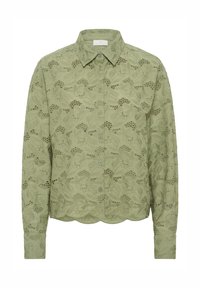 Chemise à manches longues vert clair avec broderie florale, fermeture à boutons et ourlet festonné. Tissu doux avec une finition texturée, présentant des motifs décoratifs.